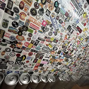 a wall of beer kegs