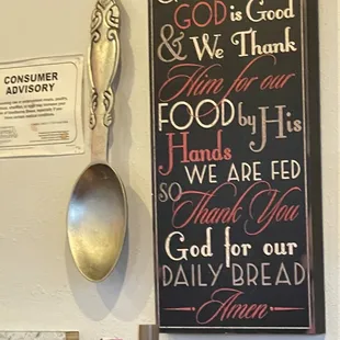 a sign with a spoon and spoon rest on it
