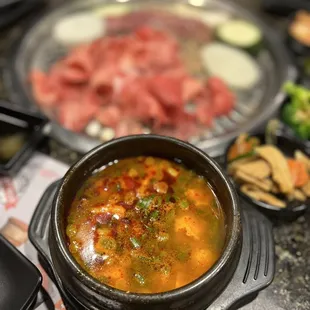  a pot of soup with meat and vegetables