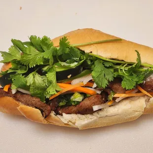 a sandwich with meat and vegetables
