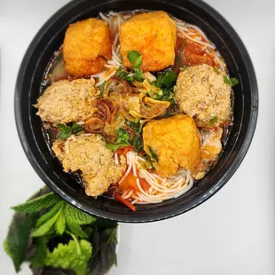 a bowl of noodles and meatballs