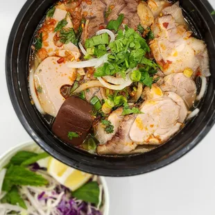 a bowl of soup with meat and vegetables
