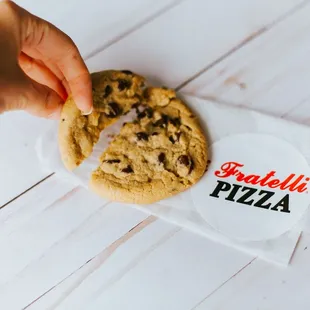 a hand holding a cookie