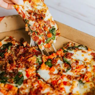 a person taking a slice