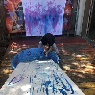 Painting with toy cars and spray bottles