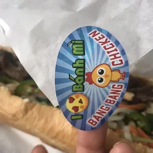 a hand holding a sandwich