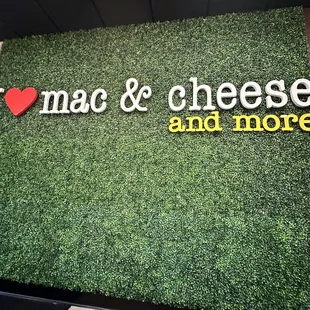 a green wall with the word i love mac and cheese and more