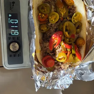 a bit under 3/4 of a lb.  Meat, cheese, onions, peppers, bread. Hot Date