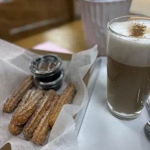 a cup of coffee and churros