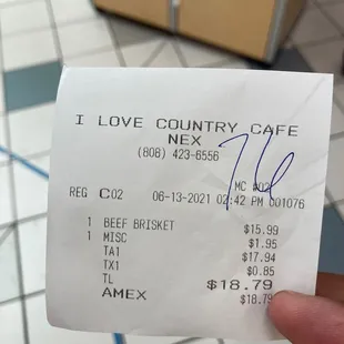 a hand holding a receipt