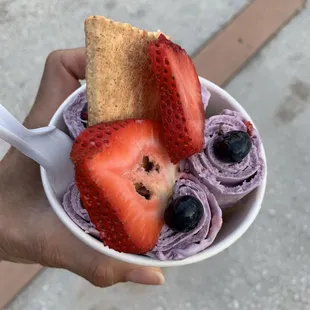 Taro ice cream with strawberries and blueberries.