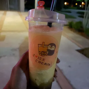 a hand holding a cup of ice cream