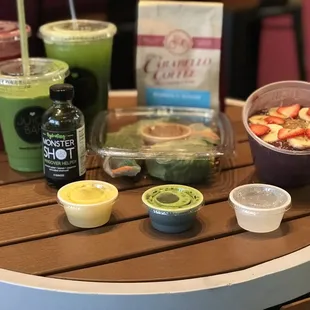Açaí bowl, spring rolls, various shots, coffee, smoothie, greens drink