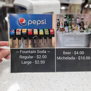 a person holding a pepsi sign