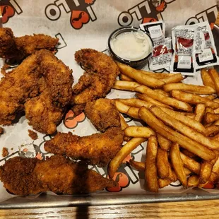 a tray of fried chicken and french fries