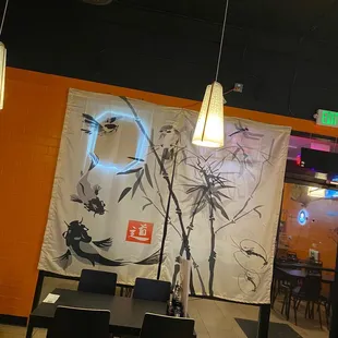 a dining area with a mural