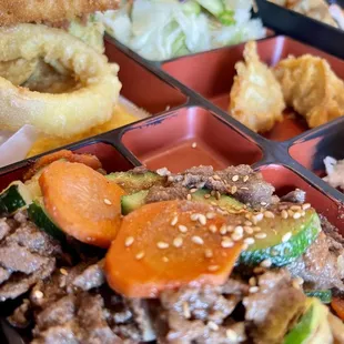 Beef Bulgogi Teriyaki Bento Box with 2 Shrimp Tempura, Mixed Veggie Tempura, White Rice, 2 Gyoza, Ginger Salad.