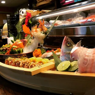 Assorted sushi and rolls presented in a boat.