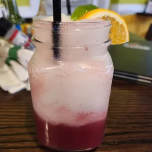 a pink drink in a mason jar