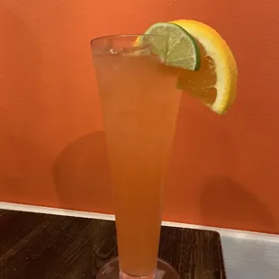 a tall glass of orange juice