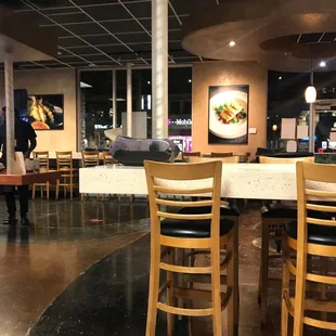 a dining area with tables and chairs