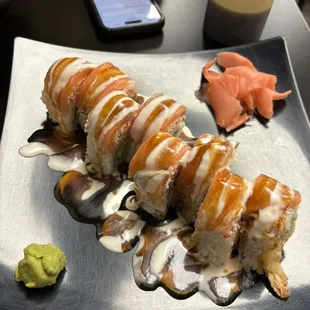O.M.G Roll (inside: Avocado, D.F Shrimp, cream cheese) (on top: crab mix, fresh salmon, teriyaki sauce, pineapple sauce(white sauce) )