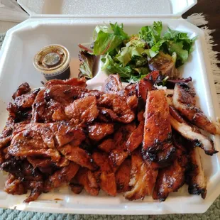 Pork and chicken, salad (veggies) all atop white rice