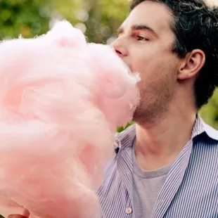 a man eating a cotton candy