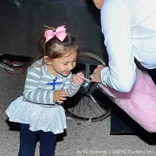 a little girl playing with a skateboard