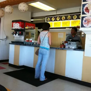 a woman standing at a counter