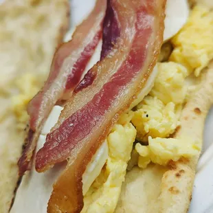 bacon, eggs, and bread on a plate