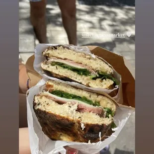 a person holding a sandwich