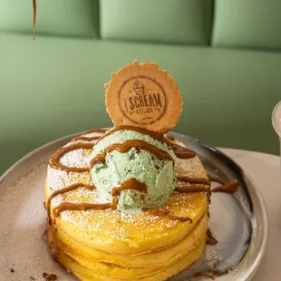 a stack of pancakes with a scoop of ice cream on top