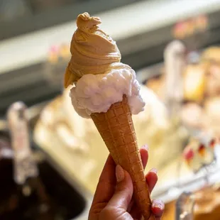 a hand holding an ice cream cone