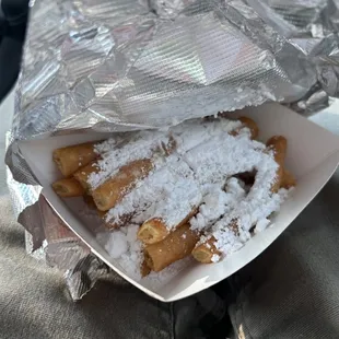 Funnel cake fries covered in powdered sugar