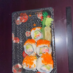a plate of sushi and vegetables