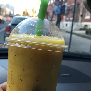 a hand holding a cup of iced coffee