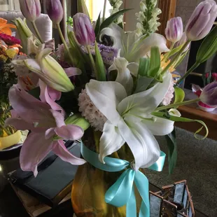 Custom design with &apos;lots of lilies, daisies and purple&apos;.