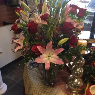 a docen roses half a docen starglazer lilies some mix greens beautiful vase all this for $80 I was paying much more  thank you!!