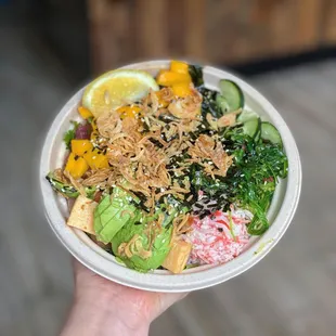 a person holding a bowl of food