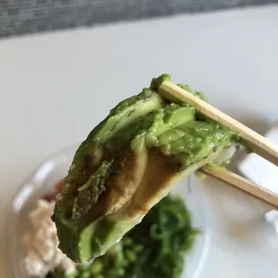 avocado with obvious rotting part shot 1 of 2