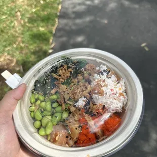 a person holding a bowl of food