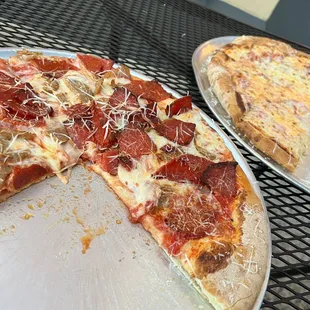 The Dom with sausage and pepperoni, and the Quattro Cheese
