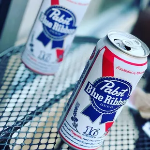 two cans of blue ribbon beer