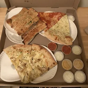 Chicken Alfredo, Pepperoni, and Cheese slices of pizza with Ian Sticks and various dipping sauces