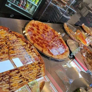 Pizzas Pizzas all lined up in a row.