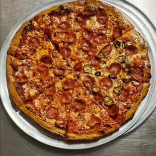 a pepperoni pizza on a pan