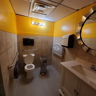 a bathroom with yellow walls