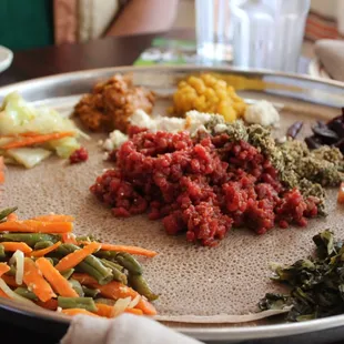 Insanely delicious platter of yummy kitfo (center, spiced raw beef) with veggies at Walia Ethiopian in Takoma Park, MD