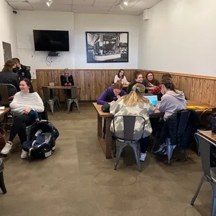a group of people sitting around a table
